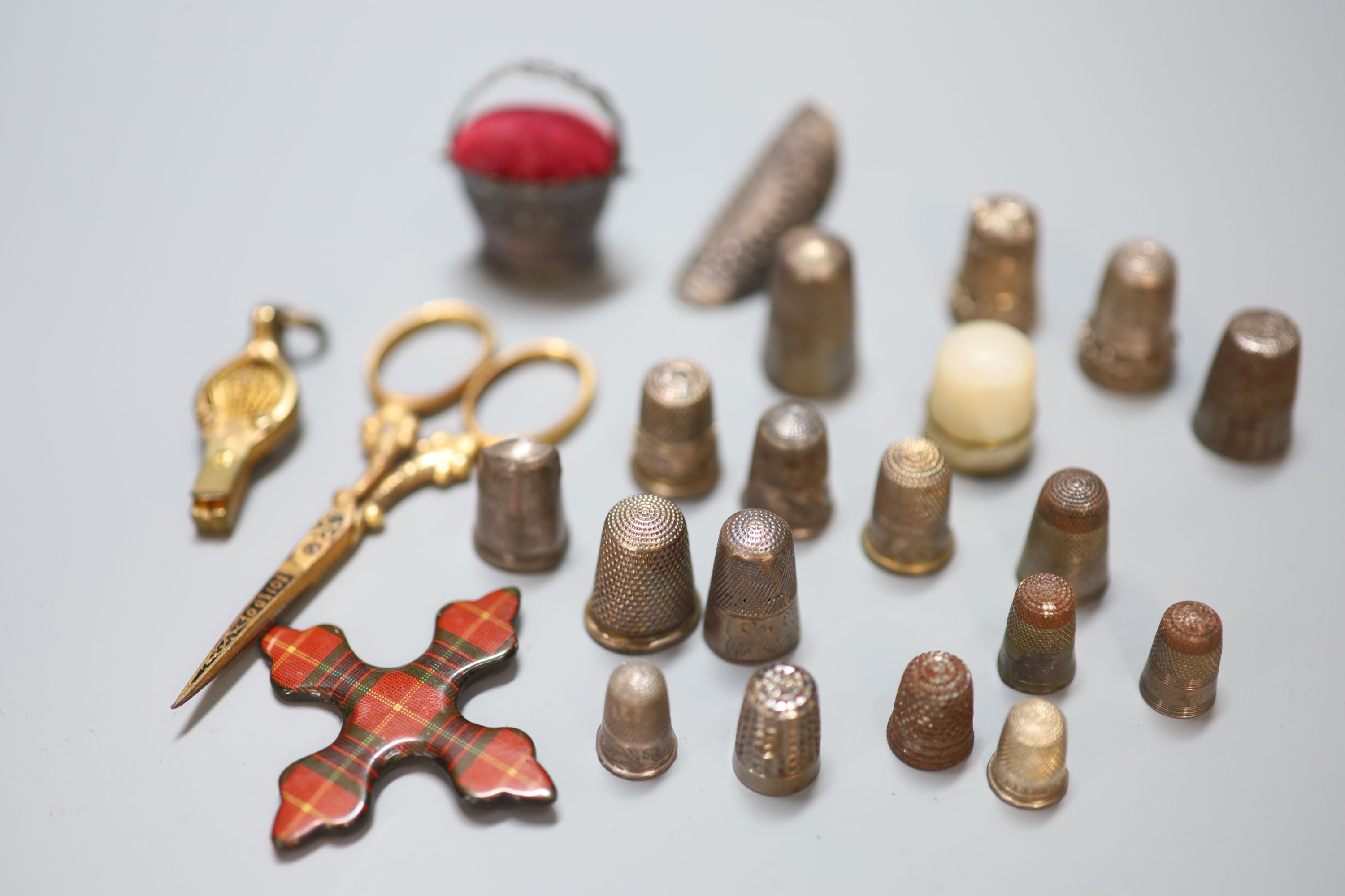 A collection of assorted thimbles and other sewing accessories